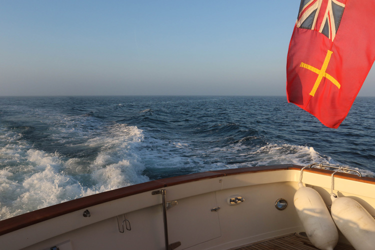 The Guernsey ensign enjoys the morning sun