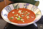 Gazpacho, dressed with diced cucumber and shreds of basil